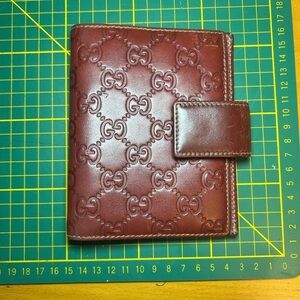 Vintage Gucci embossed GG leather notebook case in a burgundy red